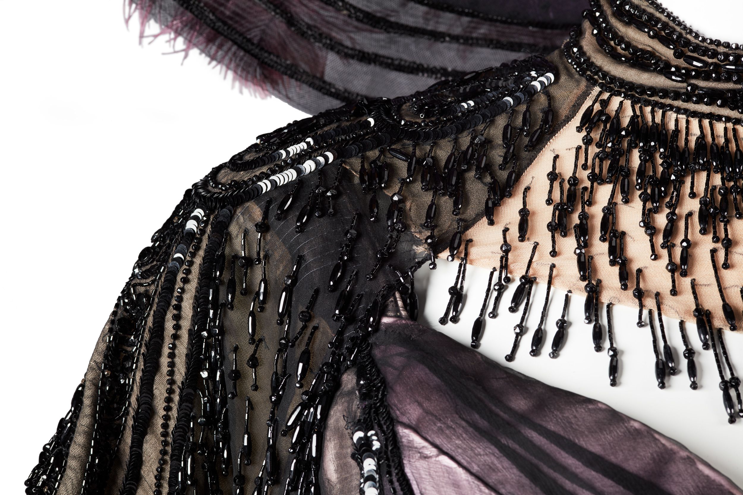 A close-up of part of the Merry Widow dress, showing the extensive use of black glass beading as a decorative element.