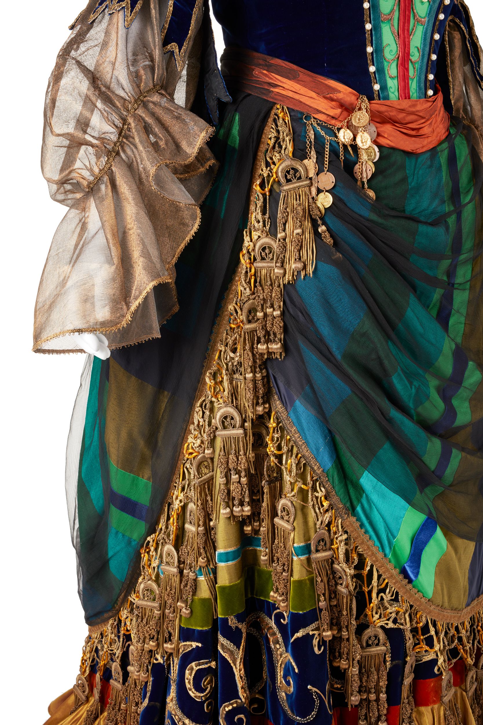 A close up of the sleeve of the conserved costume, showing intact translucent golden fabric