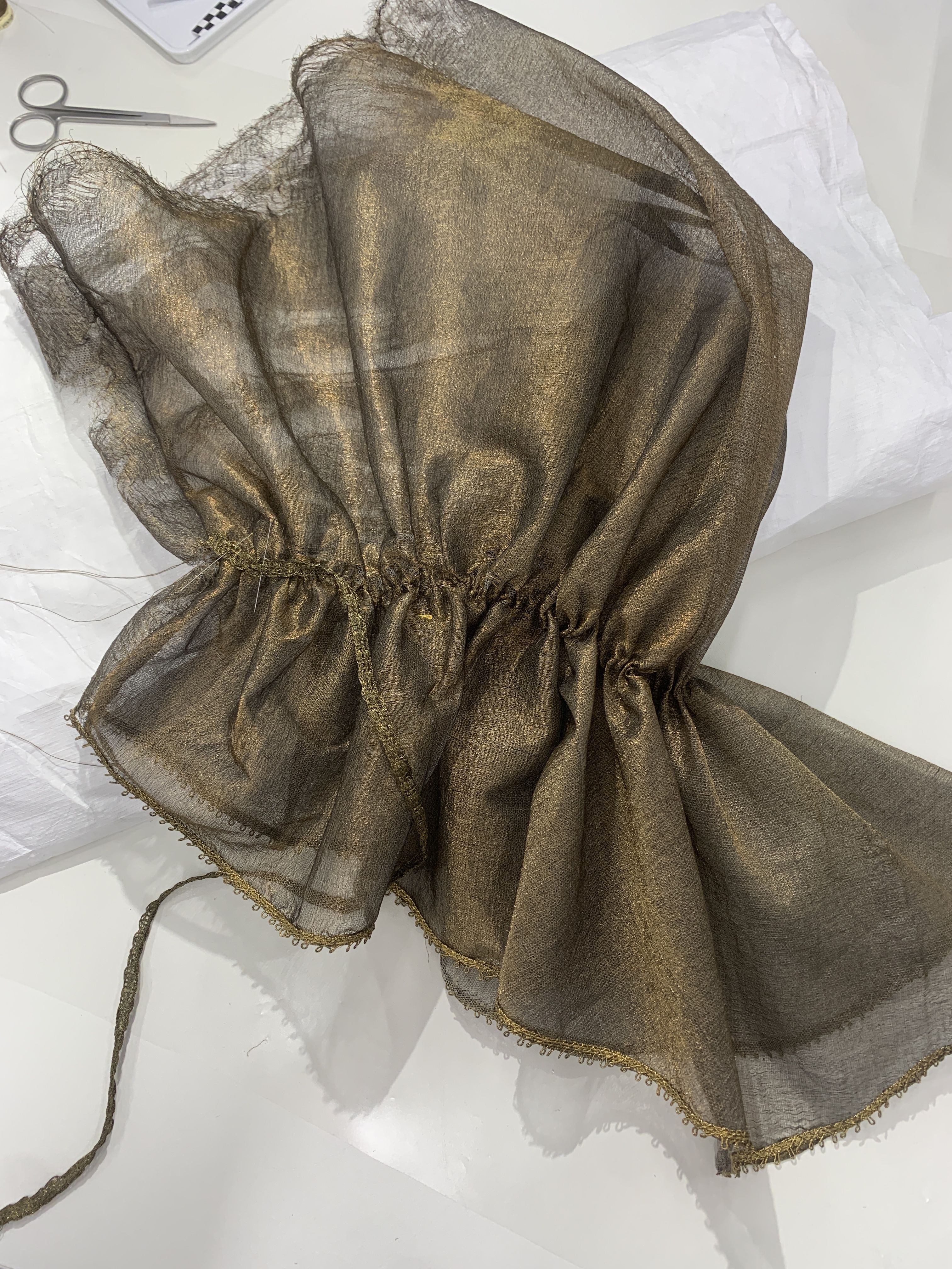 A close-up of a length of ruched golden fabric