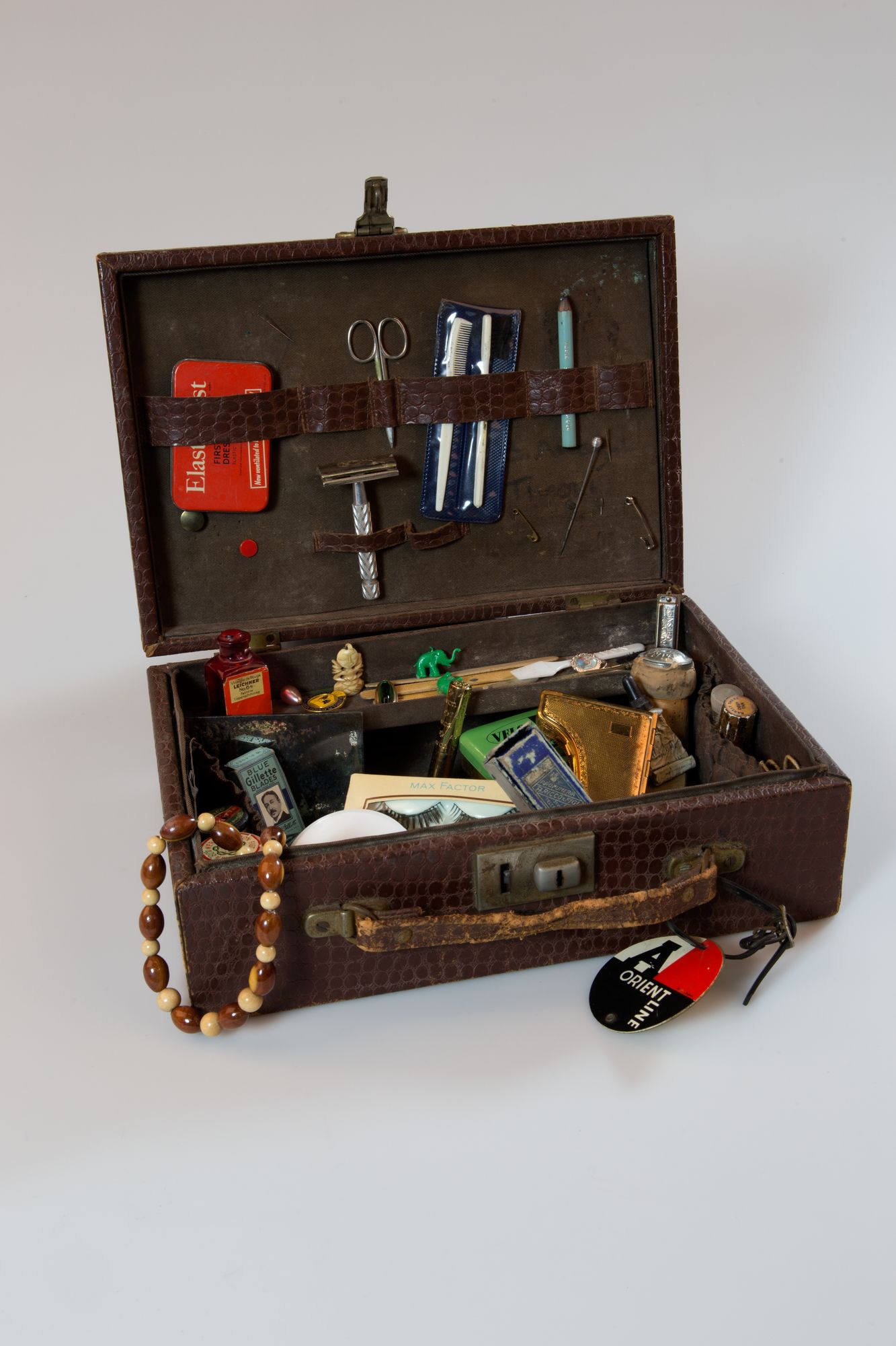 Another image of the make-up case with its lid open, showing it filled with trinkets and personal items.