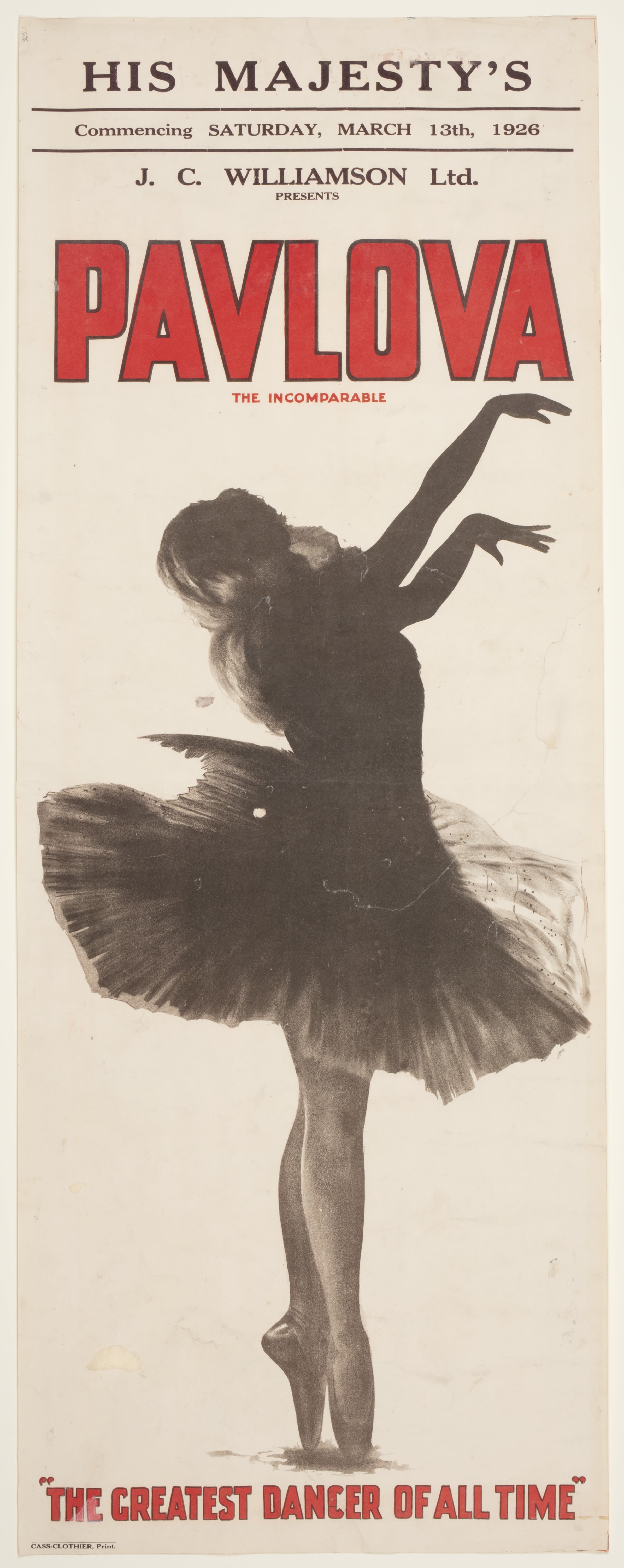 Early twentieth century theatre advertisement poster. Poster of a ballerina dancing. She is wearing a tutu and her feet are en pointe, with her hands up in the air to the right. Her head is tilted back to the left. Image almost looks like she is a shadow. 'PAVLOVA' written in red bold text above, 'THE GREATEST DANCER OF ALL TIME' writted in red bold text below image.