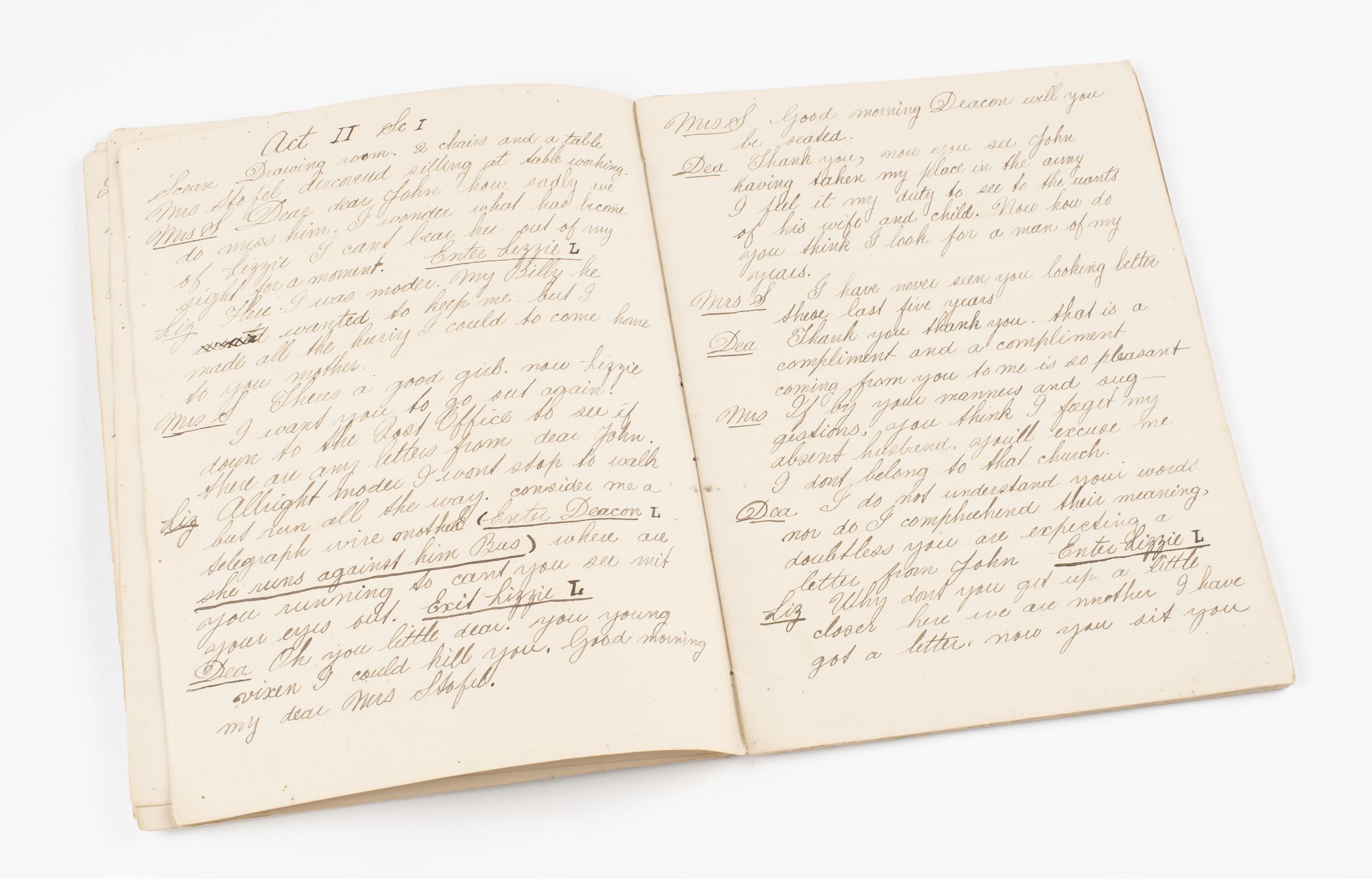 Book open with handwritten cursive writing on both pages of script dialogue. 