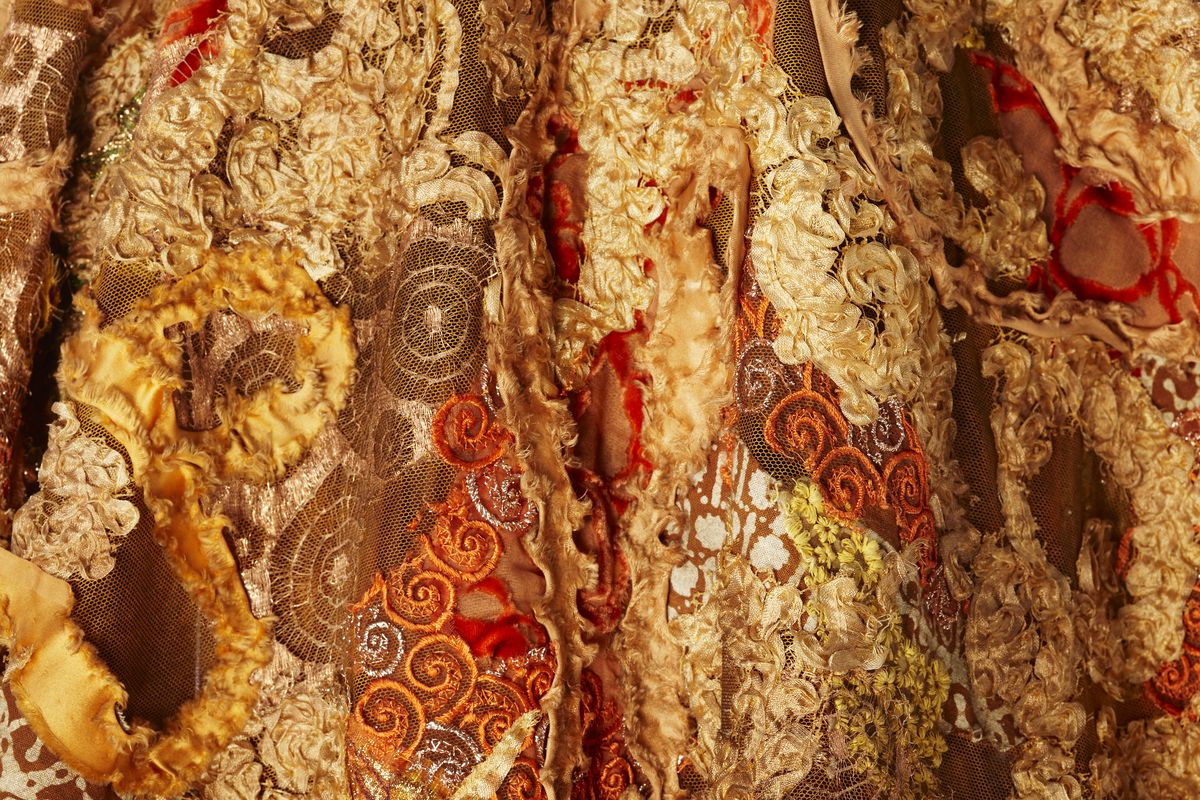 Detail of shawl showing gold and orange embroidery.