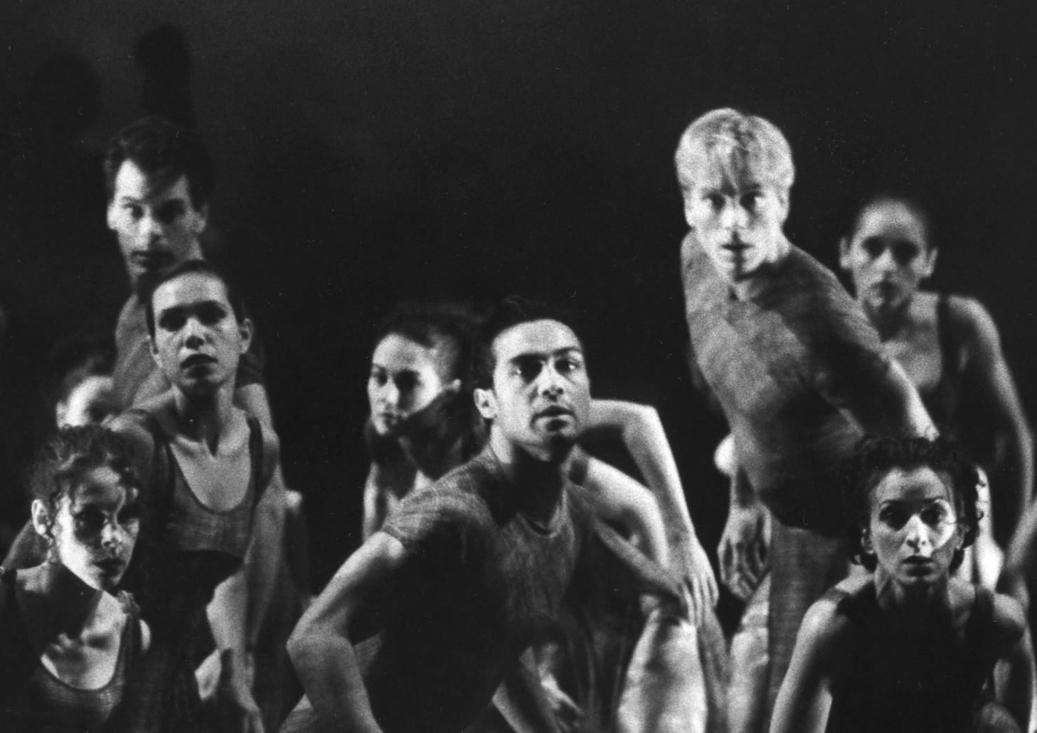 Black and white photo of male and female dancers looking at the camera.