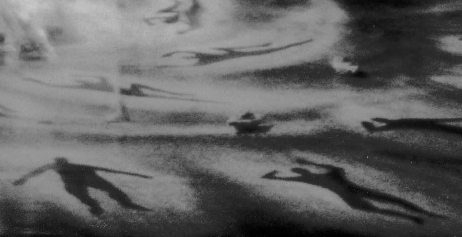 Silhouetted outlines of bodies on a stage floor..