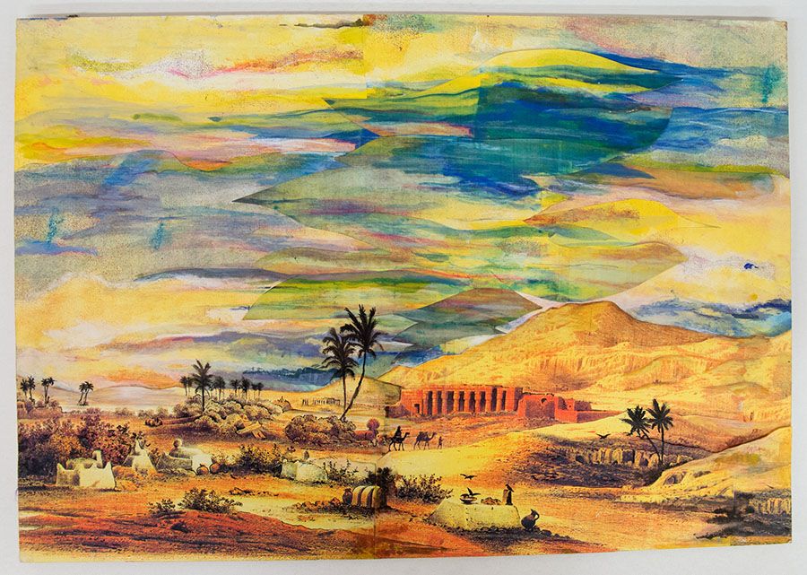 Painted scenery design featuring a desert like landscape with buildings, palm trees and mountains.
