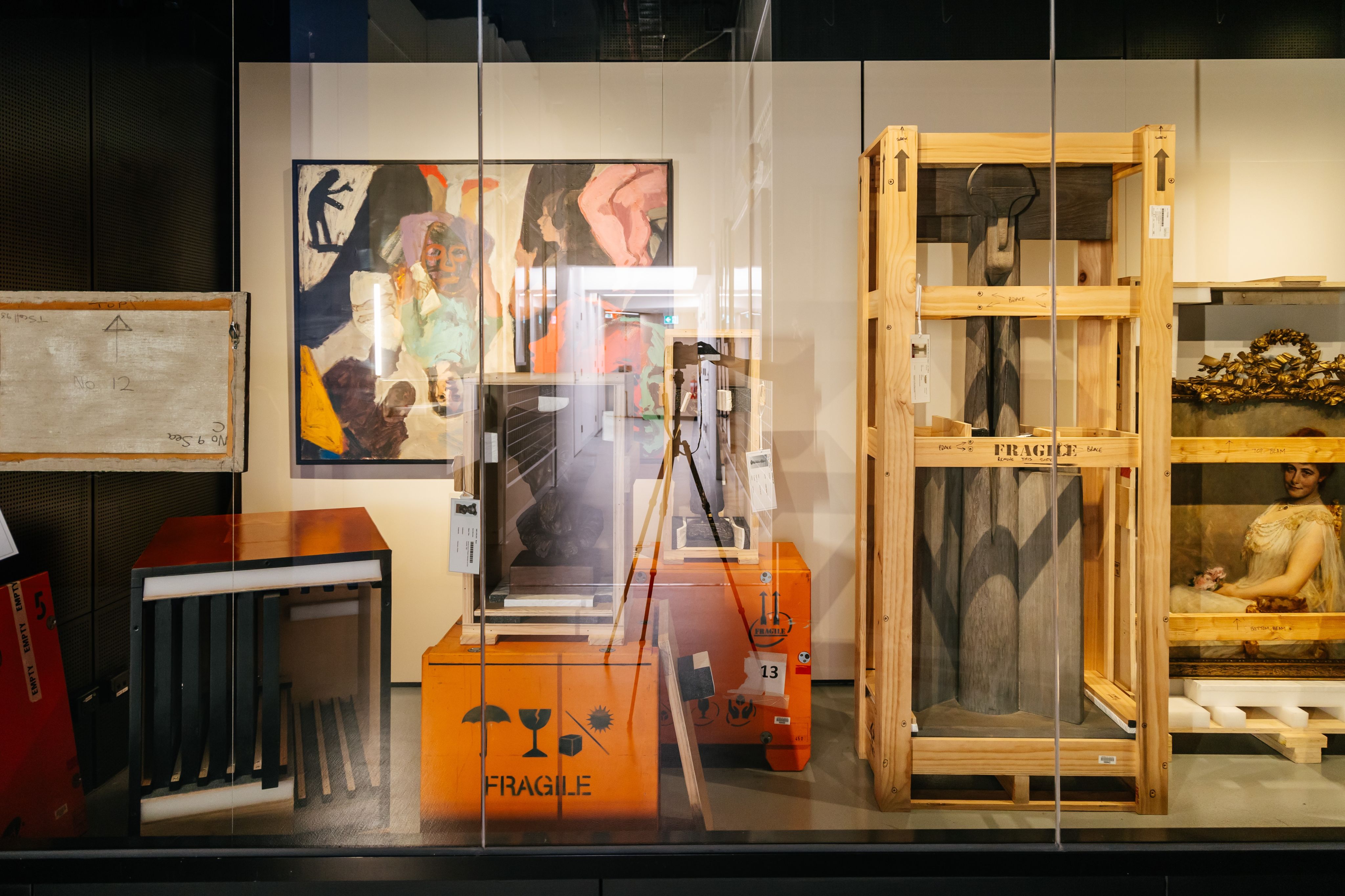 Photograph of artworks and sculptures in various states of crating and packing.