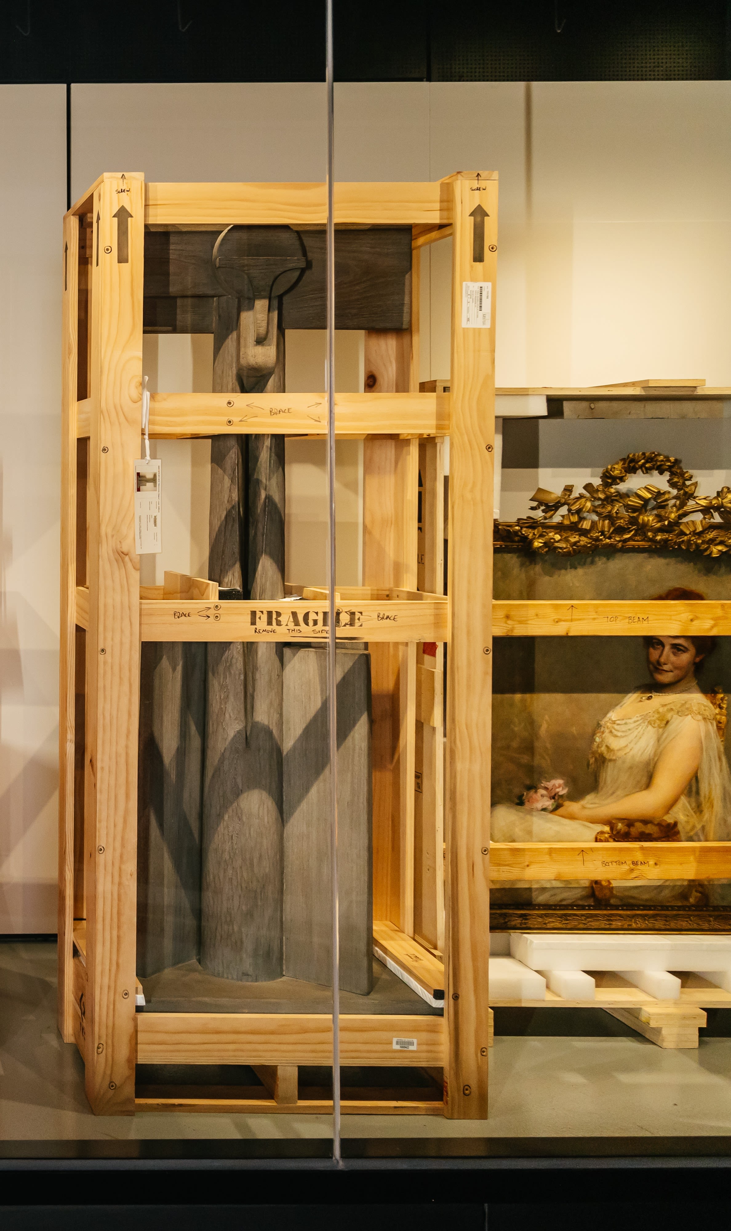 Photograph of a sculpture and artwork in crates.