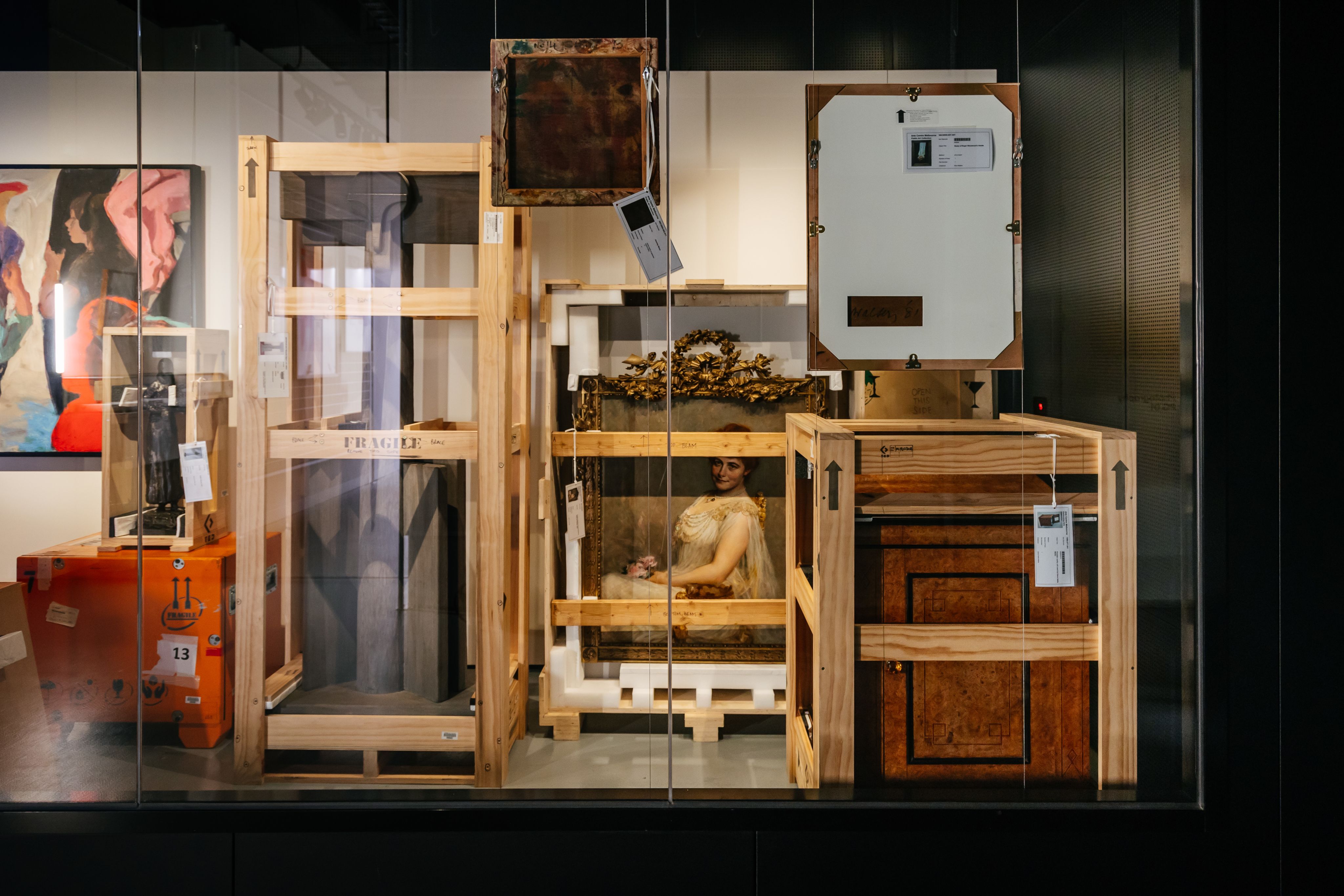 Photograph of artworks and sculptures in various states of crating and packing.