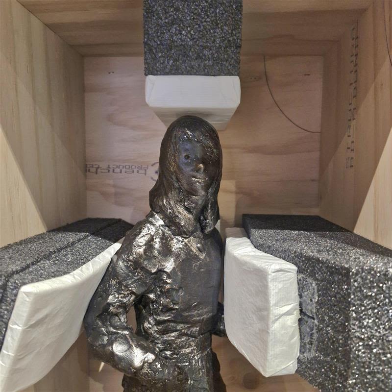 Close up photograph of a and sculptures in a crate.