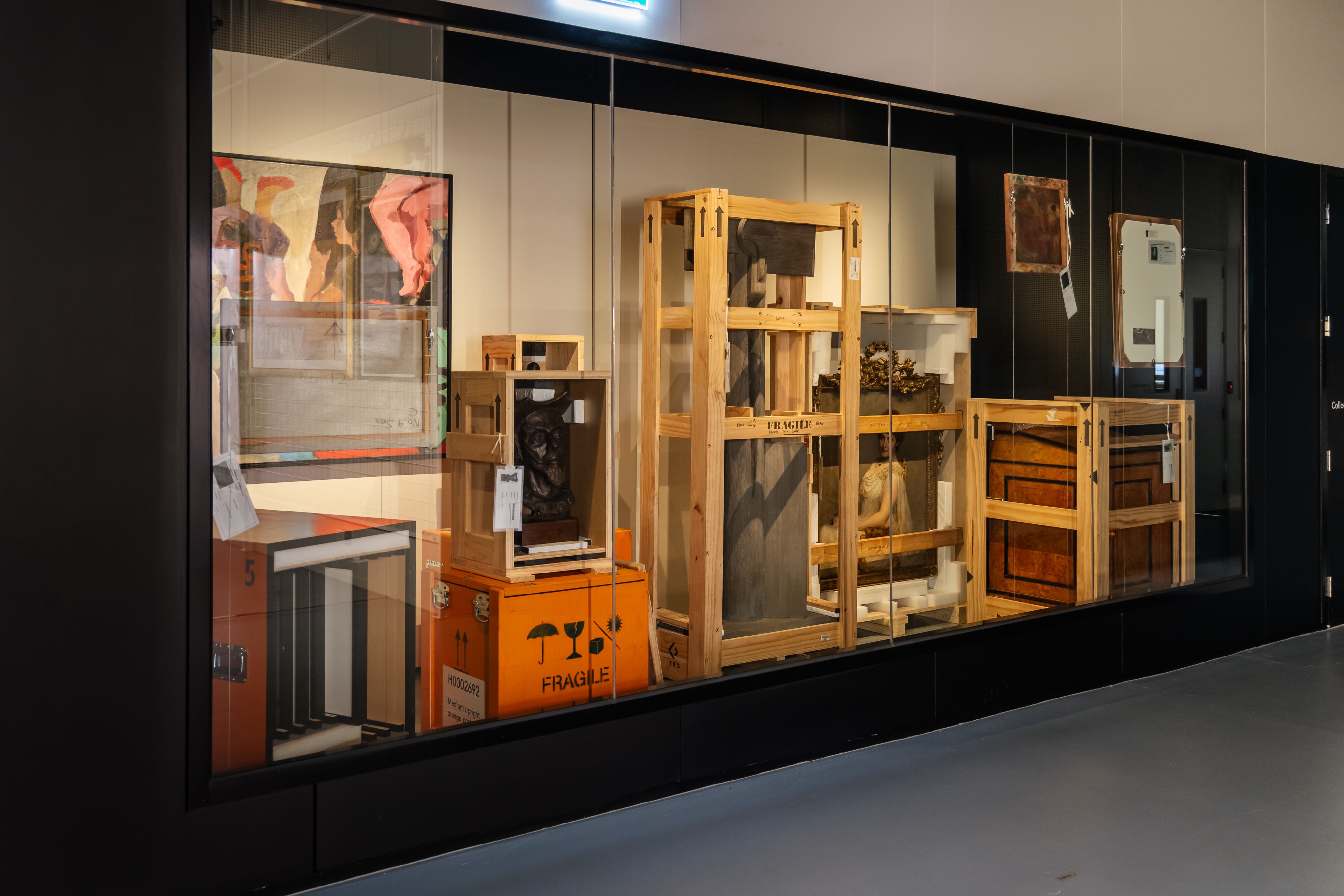 Photograph of artworks and sculptures in various states of crating and packing.