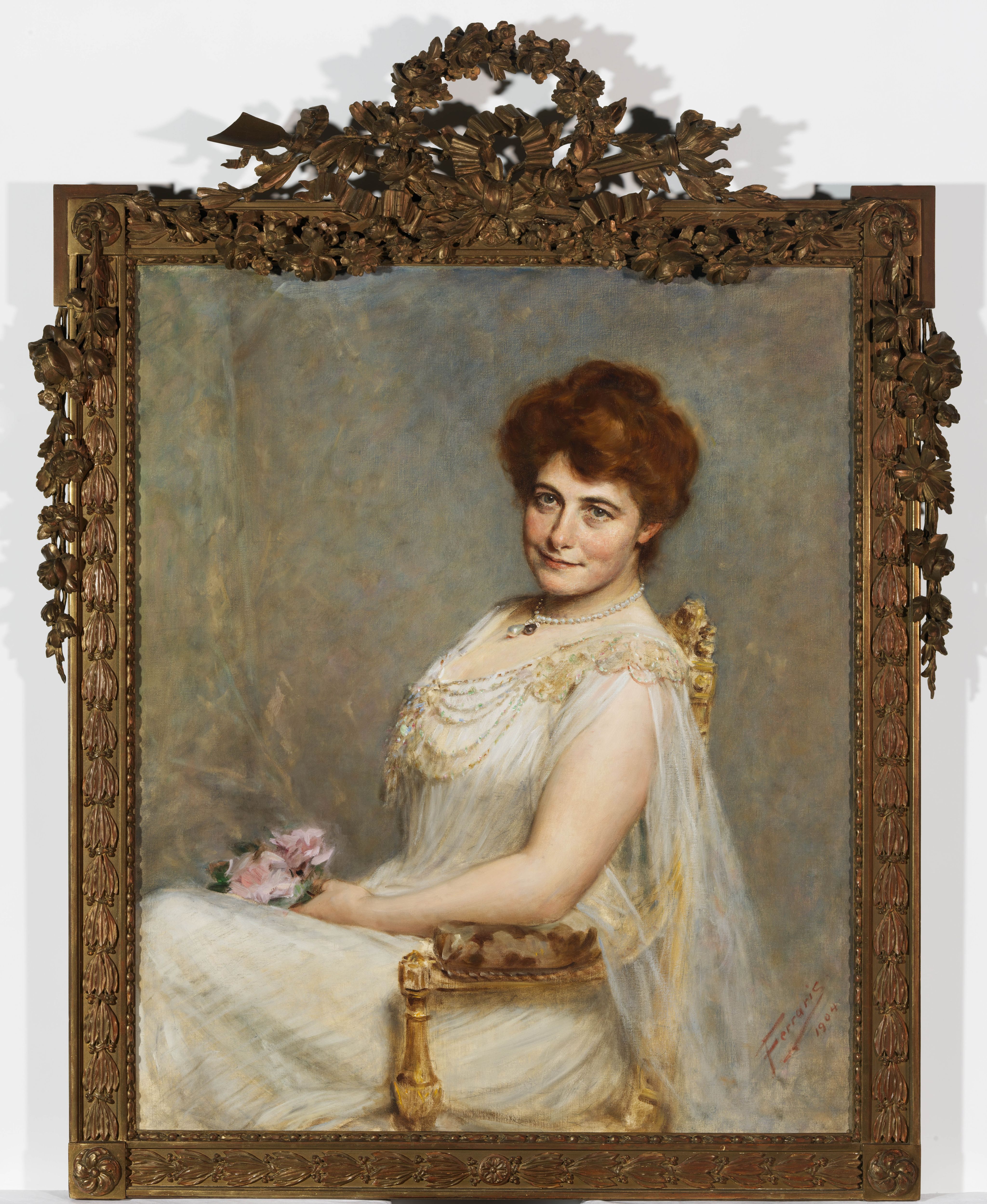 Close up photograph of a painting of a woman in 19th century dress. The painting is framed in ornate bronze.