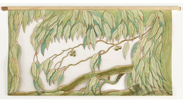 A stencil-like design of gum leaves cut out with empty space between them.