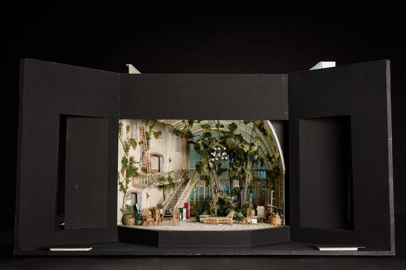 An elaborate set model showing a conservatory in a slightly faded old house, with elaborate indoor plants.