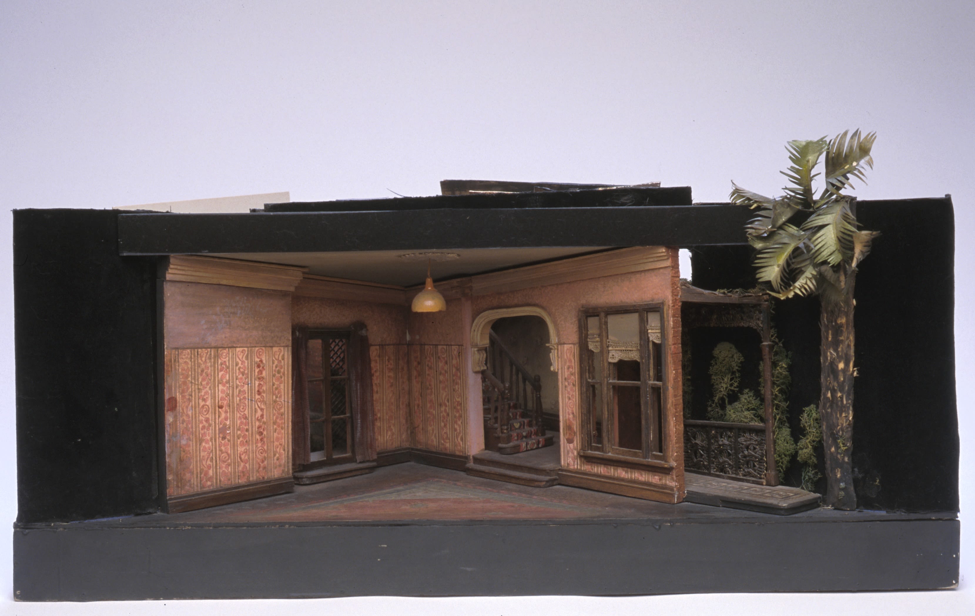 A small set model showing the 1950s interior of a terraced house.